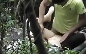 ensnared Chinese couple thing embrace in the forest