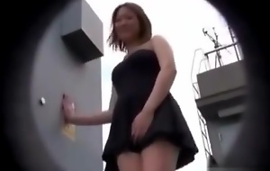 Asian teen can't do anything against the tune that lifts her dress up !
